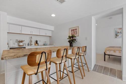 a kitchen with a bar with four stools at Stone's Throw from Capitol Hill Free Parking in Washington, D.C.