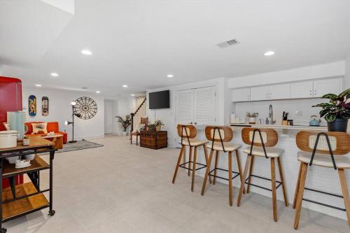 a kitchen with white cabinets and bar stools at Stone's Throw from Capitol Hill Free Parking in Washington, D.C.