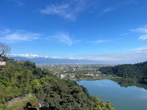 a view of a river with a city in the distance at DeerStar HomeStay B&B in Dongshan