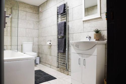 a bathroom with a sink and a toilet at Superb House near Downtown Liverpool in Liverpool