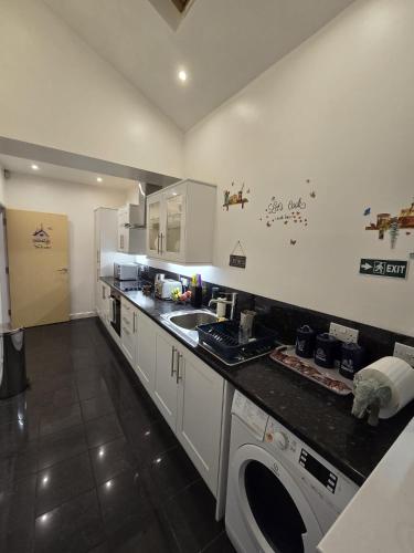a kitchen with a sink and a counter top at 38 Church Street Luxury Flat in Warrington