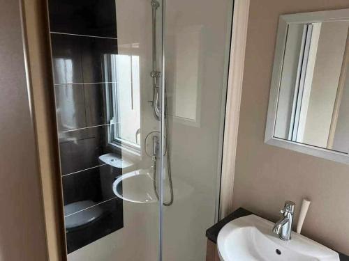 a bathroom with a shower and a sink at PG144 on the Golden Palm Chapel St Leonards 3 bed deluxe in Chapel Saint Leonards