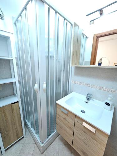 a bathroom with a sink and a shower at Clary Home Cefalu' in Cefalù