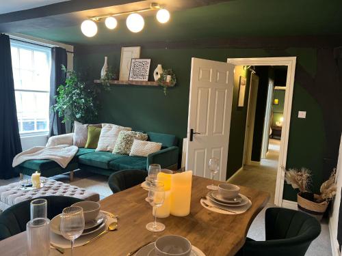 a living room with a table and a couch at Friar Loft in Worcester