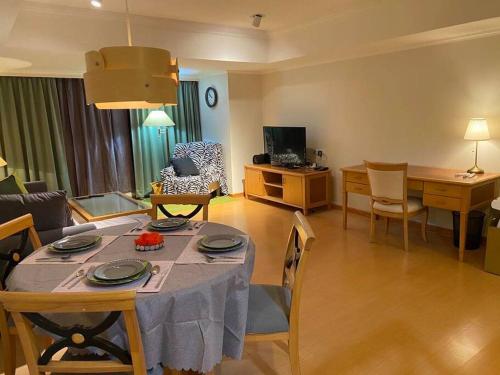 a living room with a table and chairs and a living room at Large family room near Metro Taipei station for comfort and convenience, where 5 can relax and create unforgettable moments in Taipei