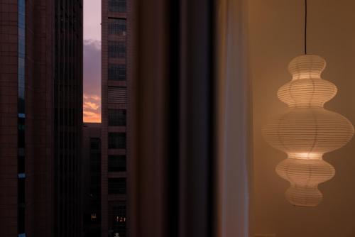 a reflection of a light bulb in a window at Molly Homestay - Nanjing East Road the Bund 3-Bedroom with Elevator Apartment in Shanghai