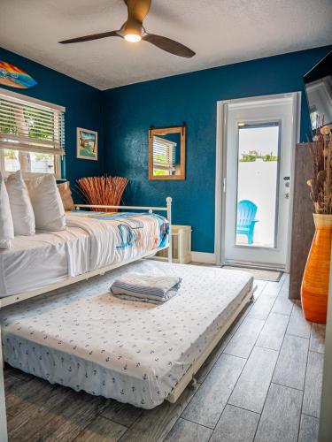 a bedroom with a bed and a blue wall at Sunny Delight I in Cape Canaveral