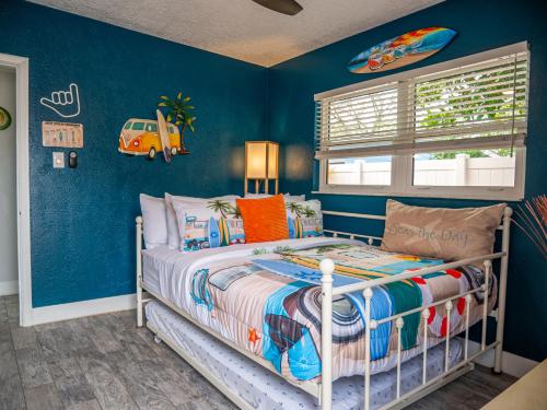 a childs bedroom with blue walls and a bed at Sunny Delight I in Cape Canaveral