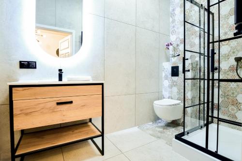 a bathroom with a sink and a mirror at VacationClub - Old Town Apartament 8B in Kłodzko