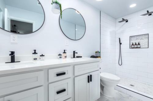 a white bathroom with a sink and a mirror at Cozy Tempe Casa with Heated Pool 5 Minutes to ASU in Tempe