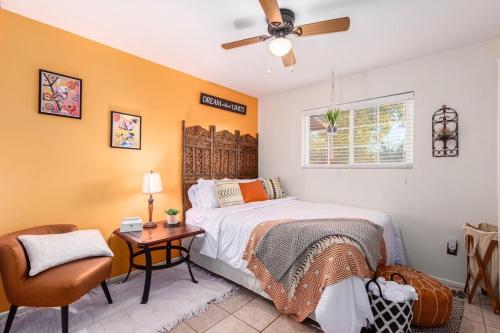 a bedroom with a bed and a chair and a window at Cozy Tempe Casa with Heated Pool 5 Minutes to ASU in Tempe