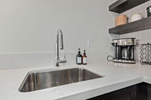a stainless steel sink in a white kitchen at LUX at Craftsman - Heart of Old Town Studio 1 in Scottsdale