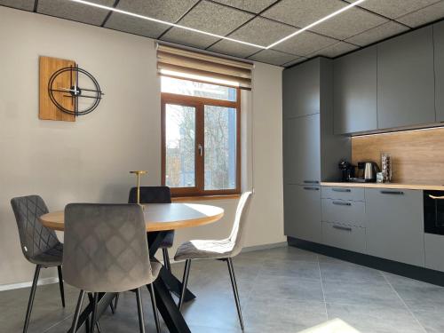 a kitchen and dining room with a table and chairs at BRIVIBAS RESIDENCE - NORTH & SOUTH, free PRIVAT parking, free WIFI, self check-in in Riga