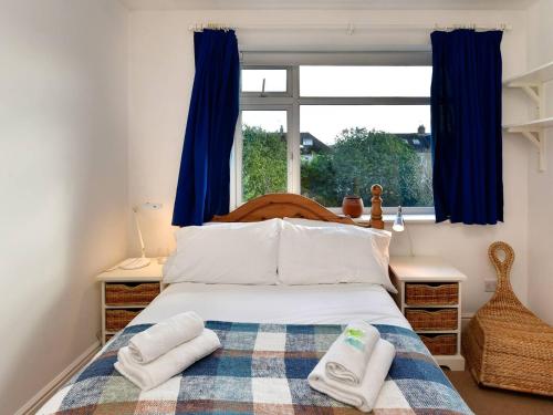 a bedroom with a bed with two towels on it at Pass the Keys A home away from home in Cardiff