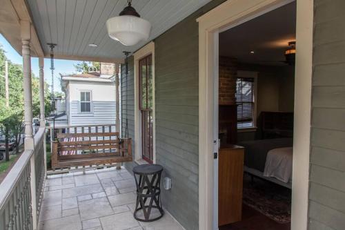 a porch of a house with a bed and a bedroom at Roof Terrace Oasis in Savannah