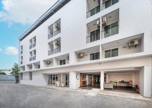 an exterior view of a white building at The Urban Oasis in Bangkok