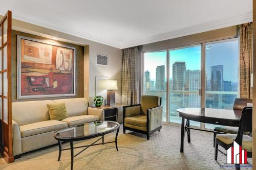 a living room with a couch and a table at MGM Signature-25-805 Balcony Strip Sphere F1 Views in Las Vegas