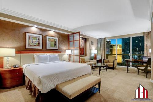 a hotel room with a large bed and a desk at MGM Signature-25-805 Balcony Strip Sphere F1 Views in Las Vegas