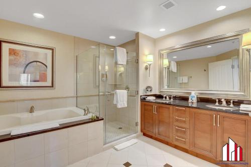 a bathroom with a tub and a sink and a shower at MGM Signature-25-805 Balcony Strip Sphere F1 Views in Las Vegas
