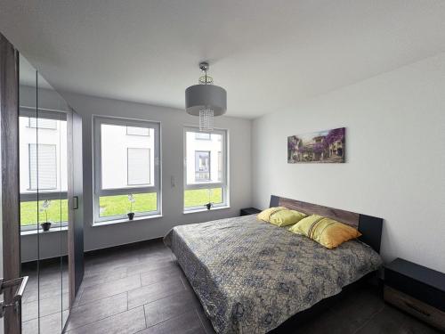 a bedroom with a bed with two pillows on it at Appartement Neugasse de Luxe - Komfort & Stil inklusive in Bad Camberg