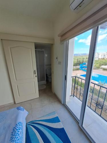 a bedroom with a sliding glass door and a balcony at Sapphire L44 in Iskele