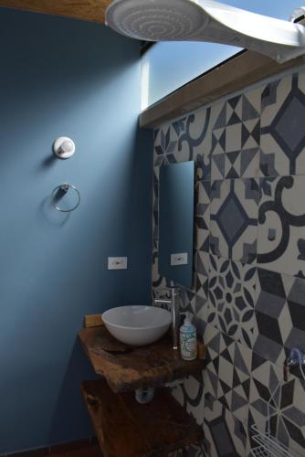 een badkamer met een wastafel en een blauwe muur bij Posada Andalucia in Iza