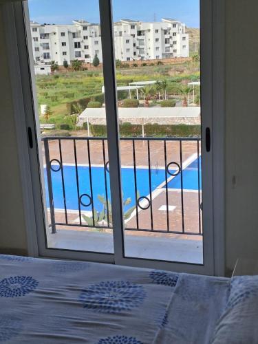 a bedroom with a view of a pool through a window at Sapphire L44 in Iskele