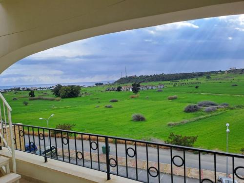 a view of a green field from a balcony at Sapphire L44 in Iskele