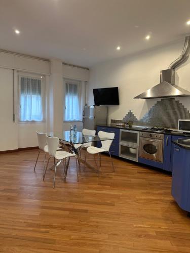 a kitchen with a table and chairs in a room at Zeffirino Apartments in Sanremo