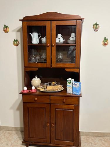 a wooden cabinet with a plate in it at Casa Belvedere Motta Camastra Gole Alcantara in Motta Camastra