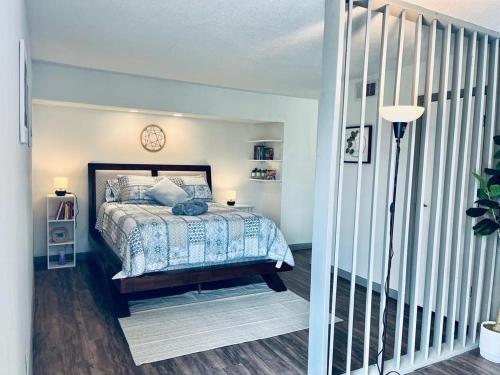 a bedroom with a bed with a clock on the wall at Heart of Houston NRG/TMC Beautiful Studio 77030 in Houston
