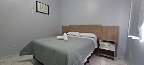 ein Schlafzimmer mit einem Bett mit zwei ausgestopften Tieren darauf in der Unterkunft Apartamento 202 mobiliado 2 quartos em Jaraguá do Sul in Jaraguá do Sul