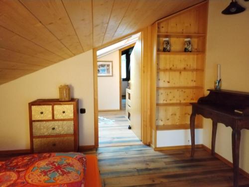 a bedroom with a bed and a piano in a room at Geographer´s Cottage in Siegsdorf