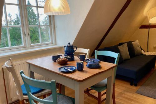 a room with a table and chairs and a couch at Ferienhof Rauchhaus in Karft