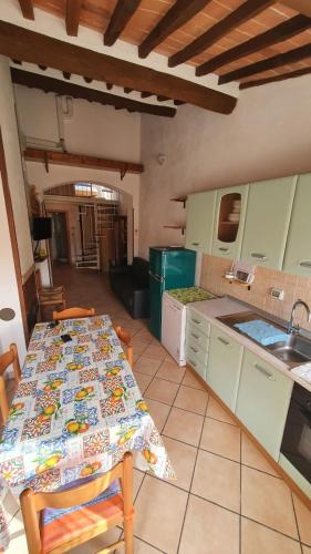 a kitchen with a table and a counter top at La Fortezza in Capoliveri