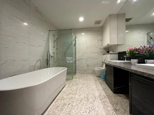 a bathroom with a tub and a shower and a toilet at Platinum suites by BLUE SKY in Kuala Lumpur