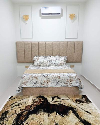 ein Schlafzimmer mit einem großen Bett und einem Teppich in der Unterkunft QQ Homestay Kuala Terengganu in Kampong Gong Badak