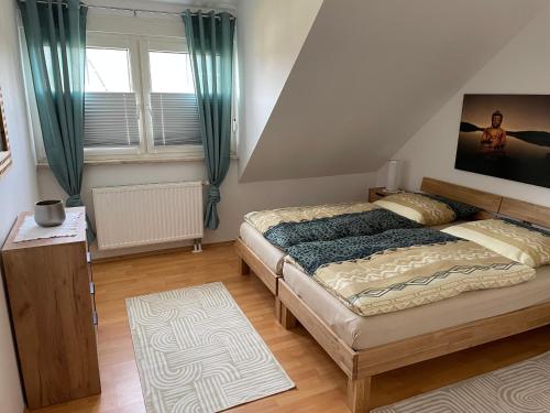 a bedroom with a bed and a large window at Noras Ferienwohnung 