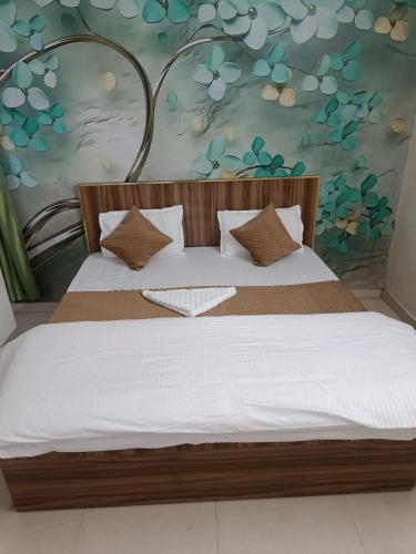 ein Schlafzimmer mit einem großen Bett mit einer Blumenwand in der Unterkunft Royal stay in Dehradun