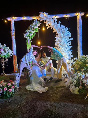 a group of people dancing under an arch at Hotel Porto Bello in San Pedro La Laguna