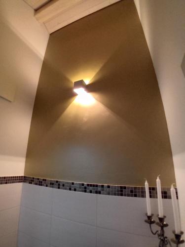 a bathroom with a light on a ceiling at Wohnresidenz Casa Fortuna in Suhr