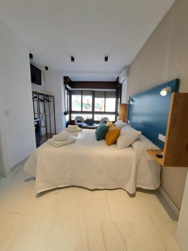 a large bedroom with a large bed with pillows at VIVAL RASTRO DELUXE in Úbeda