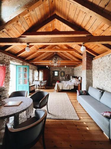 a living room with a couch and a table at Authentic Stone House Tranquil Villa for Families and Groups in Grižane