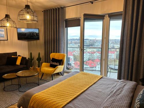 a bedroom with a bed and a view of a city at Capital Towers "FIRST CLASS" in Rzeszów