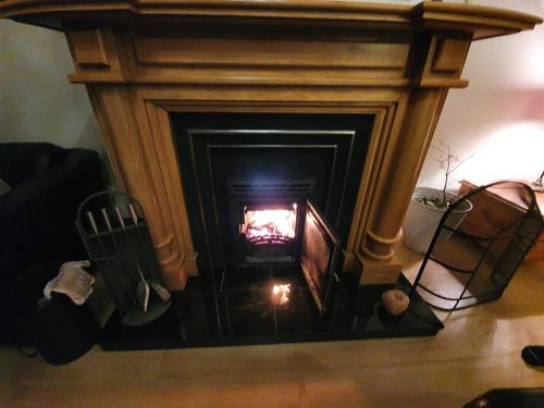 a fire in a fireplace in a living room at Glencolmcille Spectacular Views in Glencolumbkille