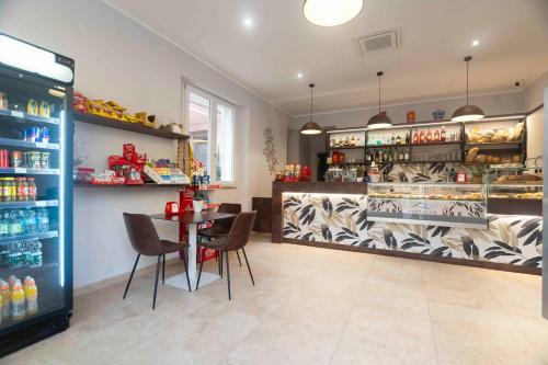 a restaurant with a table and chairs in a store at Montecristo B&B in Grosseto