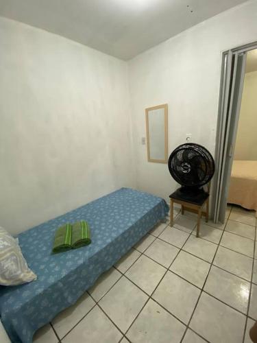 a small bedroom with a bed and a chair at Espaço Completo, bem localizado! in João Pessoa