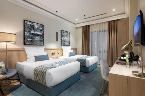 Ένα ή περισσότερα κρεβάτια σε δωμάτιο στο Marlo Hotel - فندق مارلو