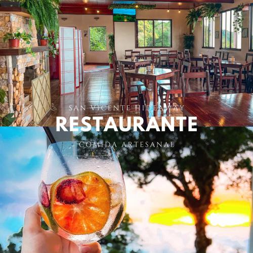 una mano sosteniendo una copa de vino con una naranja en un restaurante en Hotel San Vicente Hideaway, en Quesada