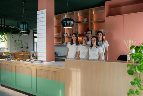 a group of women standing behind a counter in a kitchen at Al Ponticello in Comacchio